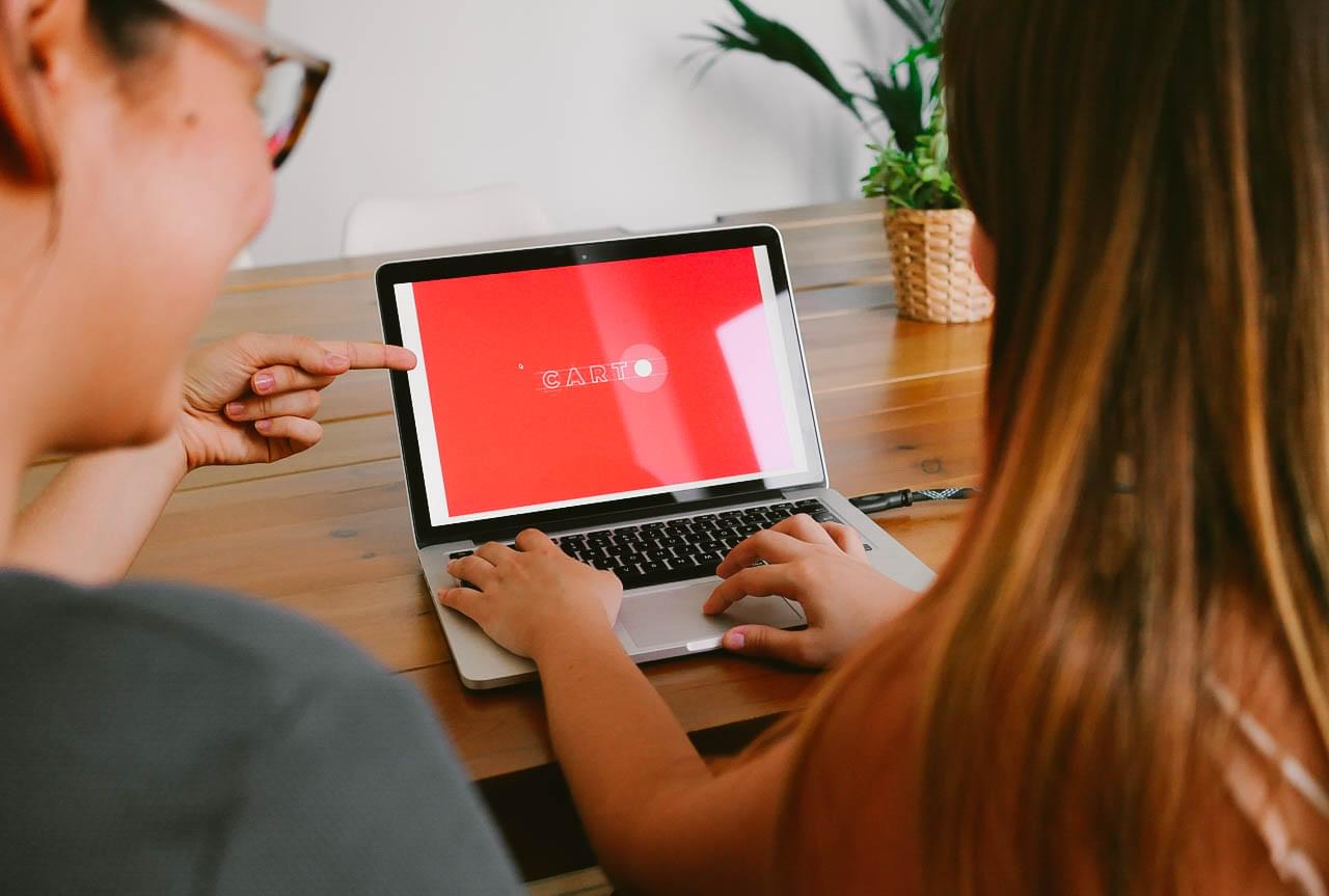 Two woman working with a computer on the new brand